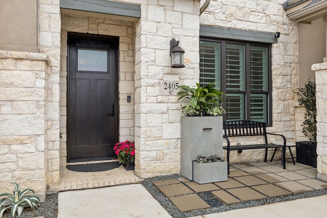 doorway to property featuring stone siding