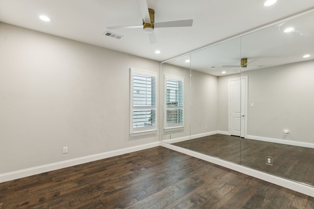 unfurnished room featuring hardwood / wood-style flooring, ceiling fan, visible vents, and baseboards