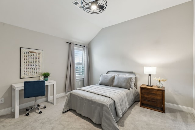 carpeted bedroom featuring lofted ceiling and baseboards