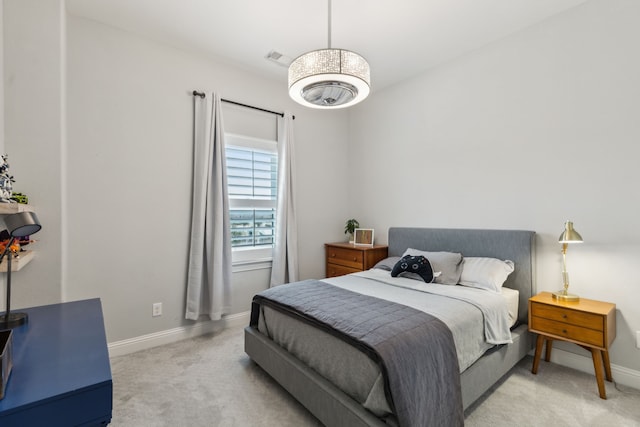 bedroom featuring baseboards and light colored carpet