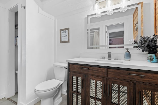 bathroom with toilet and vanity