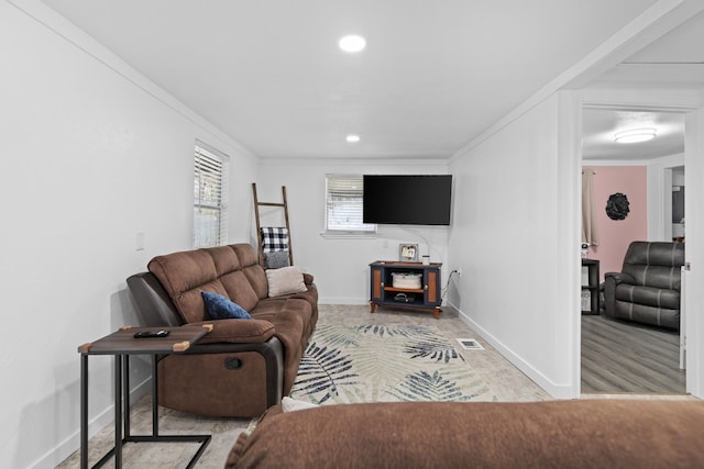 living area with ornamental molding, recessed lighting, visible vents, and baseboards