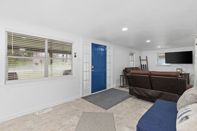 living room with recessed lighting, visible vents, plenty of natural light, and baseboards