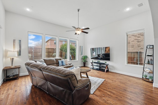 living room featuring visible vents, baseboards, a ceiling fan, wood finished floors, and recessed lighting