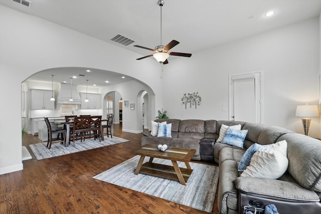 living room featuring arched walkways, ceiling fan, recessed lighting, wood finished floors, and visible vents