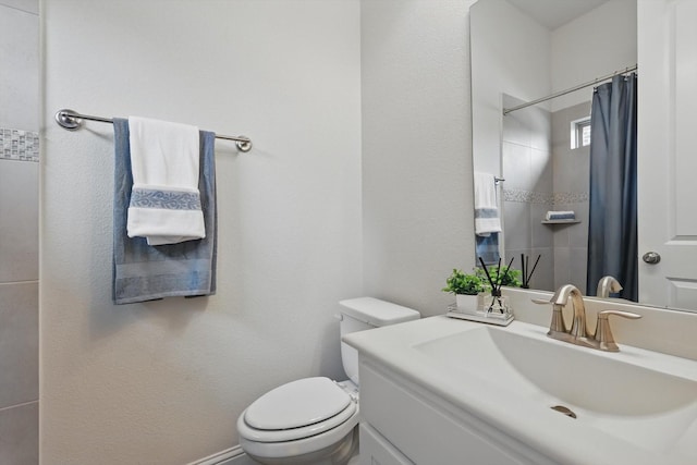 bathroom with toilet, curtained shower, and vanity