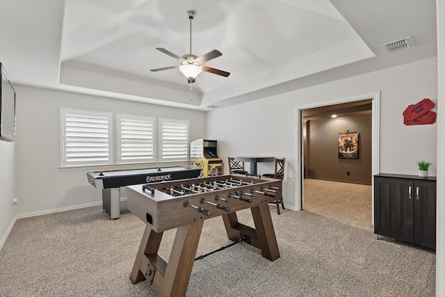 game room featuring carpet floors, a tray ceiling, visible vents, and baseboards