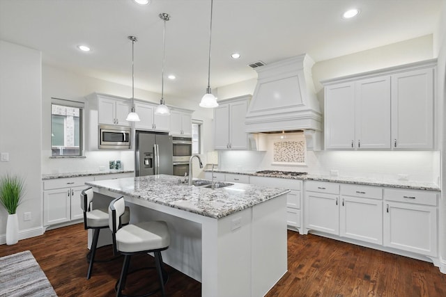 kitchen with a sink, white cabinetry, visible vents, appliances with stainless steel finishes, and custom range hood