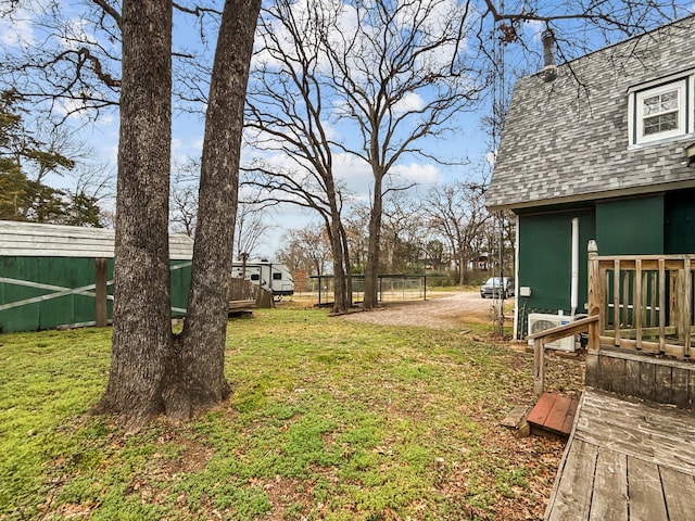 view of yard with a wooden deck and fence