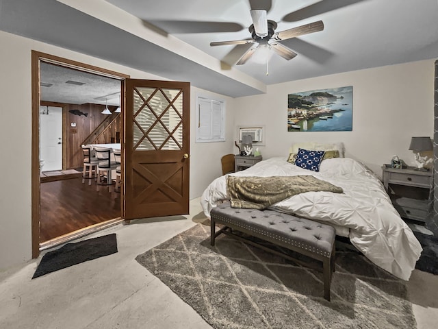 bedroom featuring concrete floors and a ceiling fan