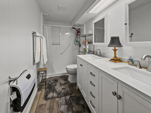 bathroom featuring wood finished floors, a sink, and a shower with shower curtain