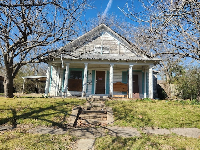 greek revival house featuring a porch and a front lawn