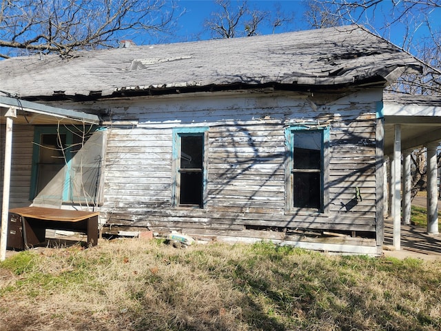 view of home's exterior with a shingled roof