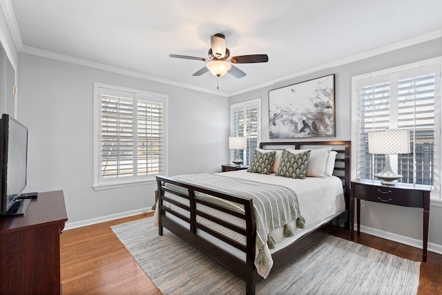 bedroom featuring ornamental molding, ceiling fan, baseboards, and wood finished floors