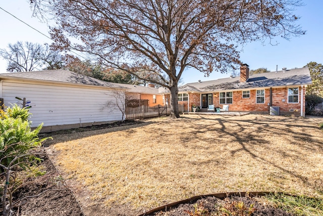 view of yard featuring central AC unit and fence