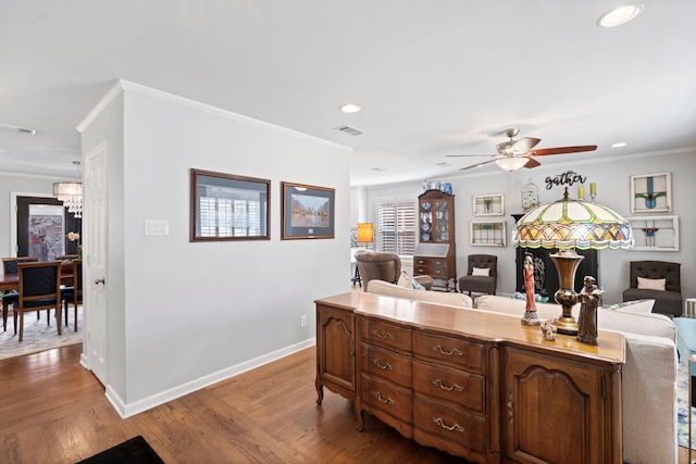 interior space featuring baseboards, visible vents, ornamental molding, open floor plan, and wood finished floors