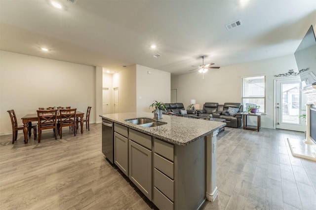 kitchen featuring a sink, visible vents, light wood-style floors, gray cabinets, and dishwasher