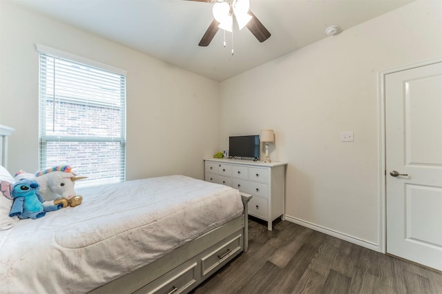 bedroom with baseboards, dark wood finished floors, and a ceiling fan