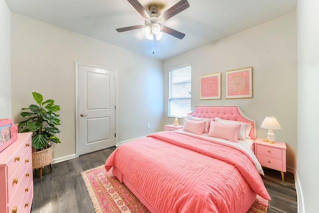 bedroom featuring ceiling fan, baseboards, and wood finished floors