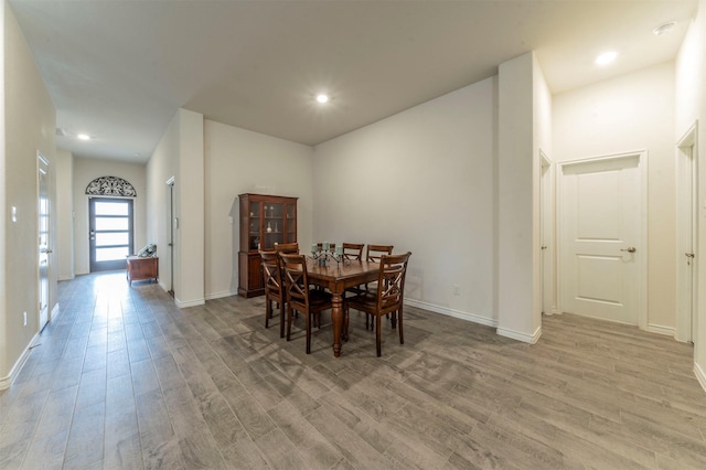 dining room with light wood-type flooring, baseboards, and recessed lighting