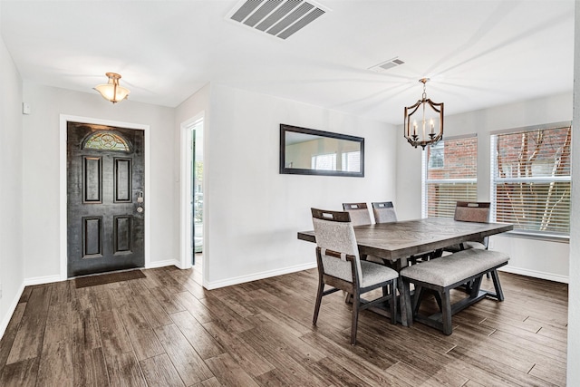 dining space featuring visible vents, dark wood finished floors, and baseboards