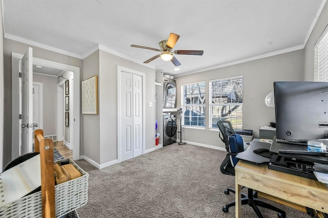 home office featuring carpet, crown molding, stacked washer / drying machine, a ceiling fan, and baseboards