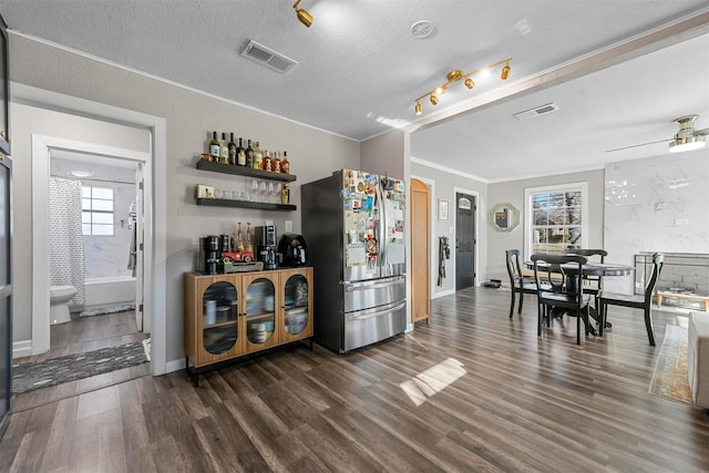 kitchen with visible vents, dark wood finished floors, a textured ceiling, and freestanding refrigerator