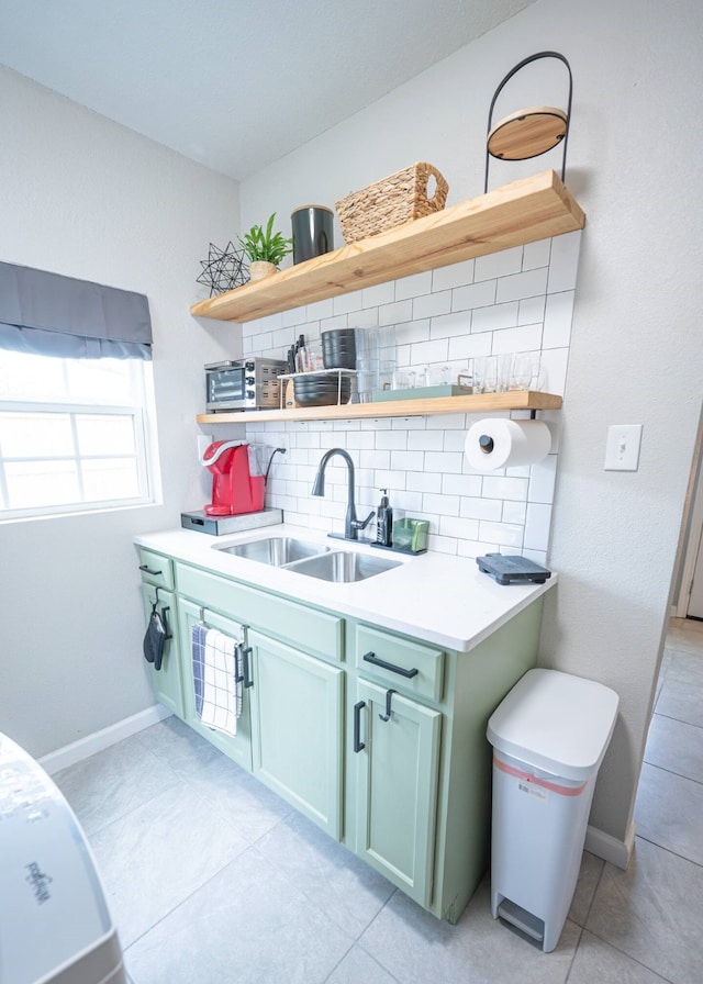 interior space featuring a sink, baseboards, and light tile patterned floors