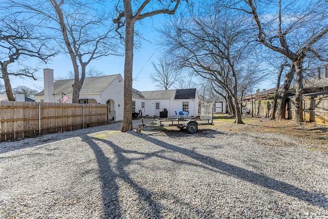 exterior space featuring a storage shed, an outbuilding, and a fenced backyard