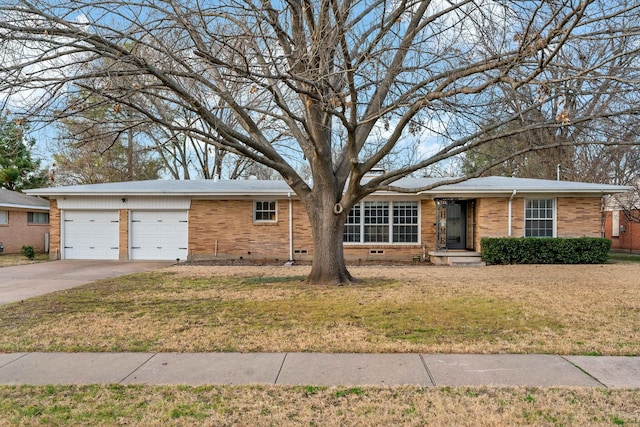 ranch-style home with concrete driveway, brick siding, crawl space, and a front yard