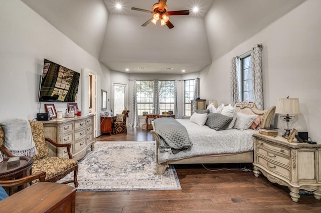 bedroom with recessed lighting, dark wood-style floors, and a towering ceiling