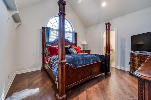 bedroom with baseboards, wood finished floors, ensuite bathroom, and vaulted ceiling