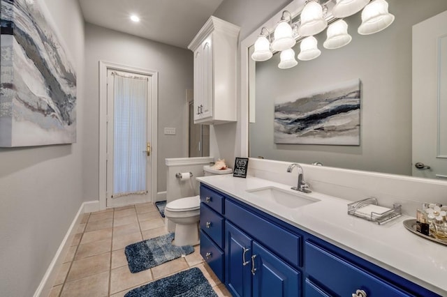 bathroom featuring tile patterned floors, toilet, vanity, and baseboards