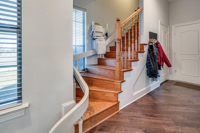 stairs featuring wood finished floors