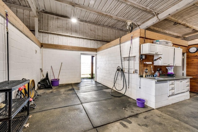 garage featuring concrete block wall and a sink