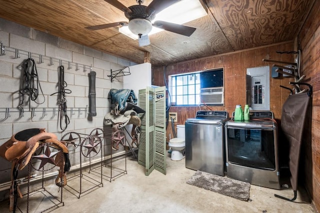 view of horse barn with electric panel and separate washer and dryer