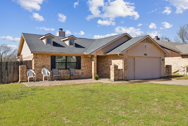 view of front of home featuring a front yard, concrete driveway, fence, and an attached garage