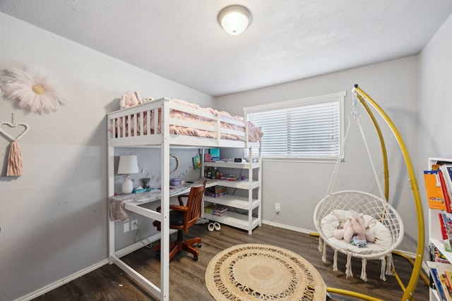 bedroom with wood finished floors and baseboards