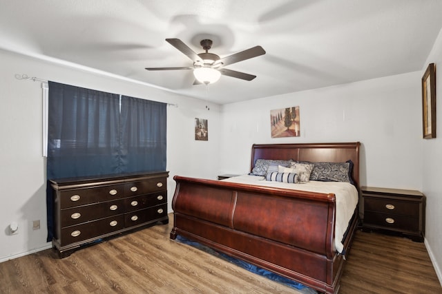 bedroom featuring baseboards, a ceiling fan, and wood finished floors