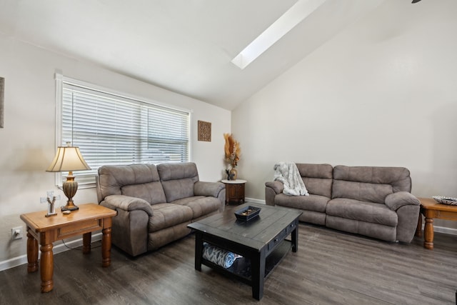 living area featuring vaulted ceiling with skylight, baseboards, and wood finished floors