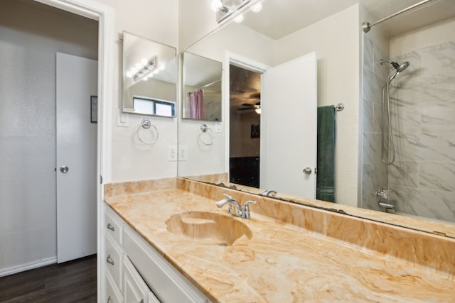 full bath with wood finished floors, vanity, and walk in shower