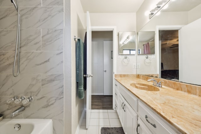 full bathroom featuring shower / bathtub combination, tile patterned floors, baseboards, and vanity