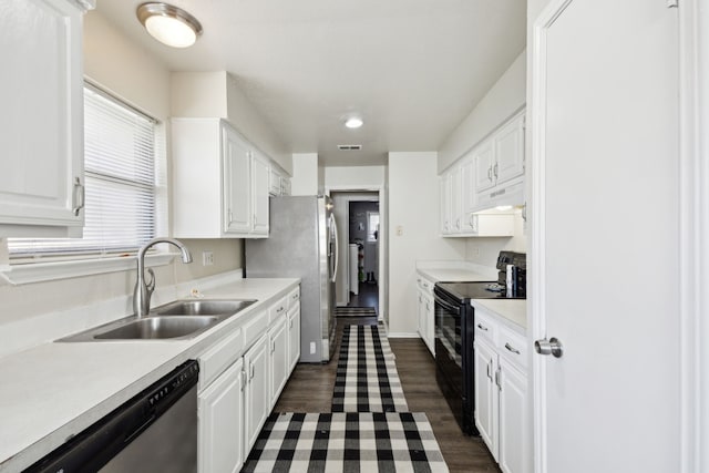 kitchen featuring white cabinets, appliances with stainless steel finishes, light countertops, under cabinet range hood, and a sink