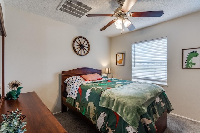 carpeted bedroom featuring visible vents, ceiling fan, a textured ceiling, and baseboards