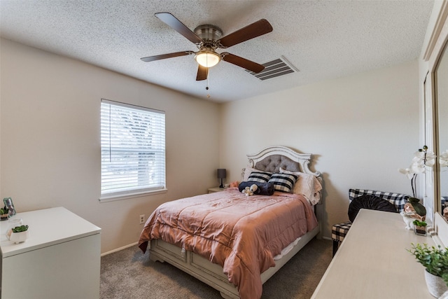 carpeted bedroom with a ceiling fan, visible vents, a textured ceiling, and baseboards