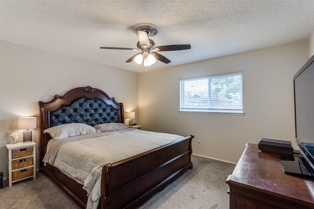 bedroom with a textured ceiling, carpet, a ceiling fan, and baseboards