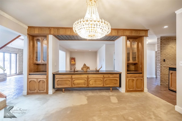 dining area with baseboards, light colored carpet, brick wall, and an inviting chandelier