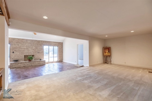 unfurnished living room with recessed lighting, carpet floors, a fireplace, a ceiling fan, and baseboards