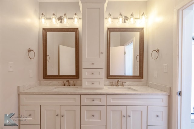 full bathroom with a sink and double vanity