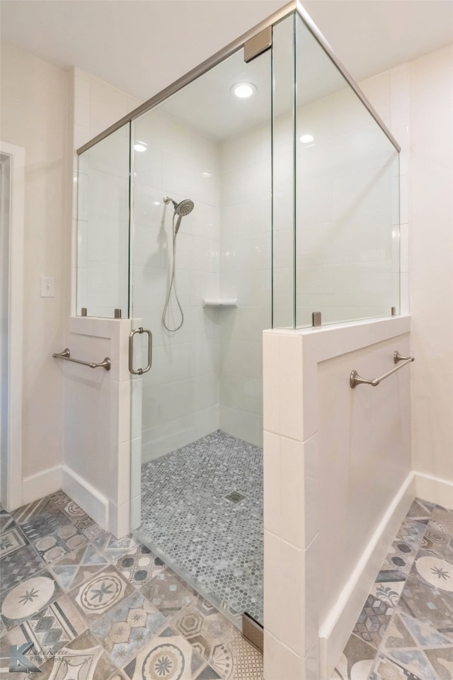 bathroom featuring a shower stall and baseboards